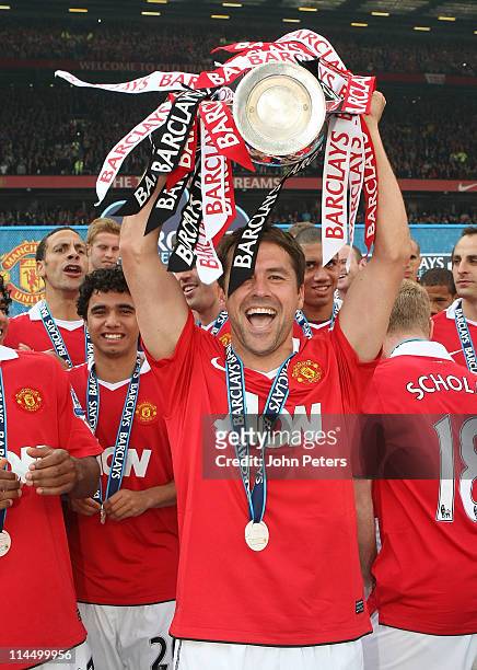 Michael Owen of Manchester United lifts the Barclays Premier League trophy after the Barclays Premier League match between Manchester United and...