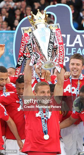 Nemanja Vidic of Manchester United lifts the Barclays Premier League trophy after the Barclays Premier League match between Manchester United and...