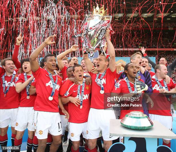 Nemanja Vidic of Manchester United lifts the Barclays Premier League trophy after the Barclays Premier League match between Manchester United and...