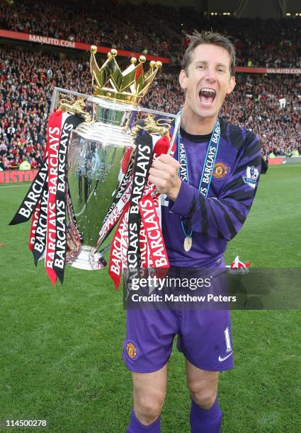 Edwin van der Sar of Manchester United celebrates with the Barclays Premier League trophy after the Barclays Premier League match between Manchester...