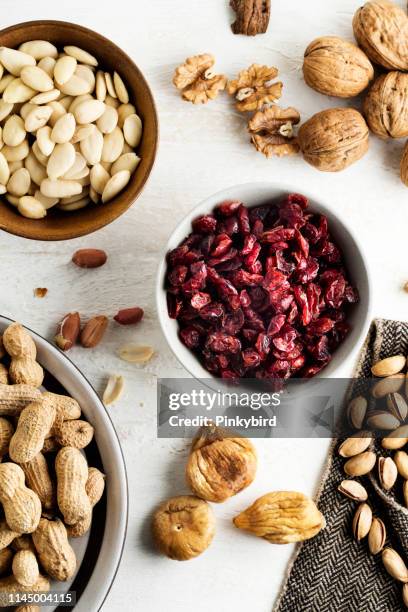 mixed nuts with cranberry,nuts and dried fruits mixed,nuts and dried fruits collection - dried food stock pictures, royalty-free photos & images