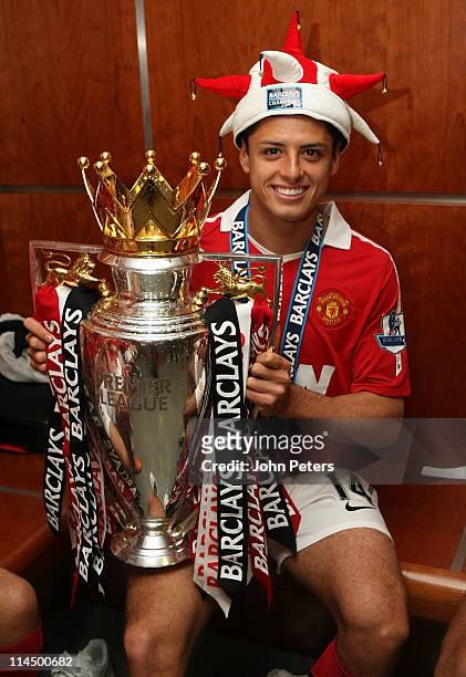 Javier Hernandez of Manchester United poses in the dressing room with the Barclays Premier League trophy after the Barclays Premier League match...