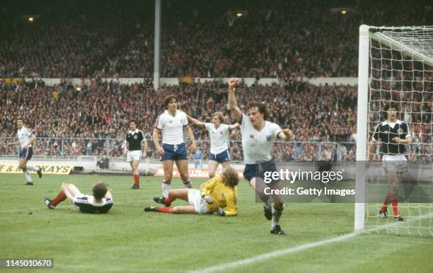 England player Steve Coppell celebrates after scoring the 2nd goal after a mistake by Scotland goalkeeper George Wood as England players Trevor...