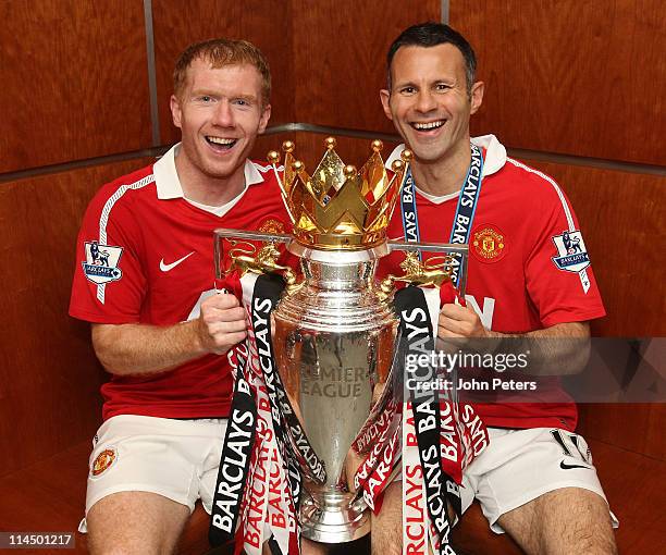 Paul Scholes and Ryan Giggs of Manchester United pose in the dressing room with the Barclays Premier League trophy after the Barclays Premier League...