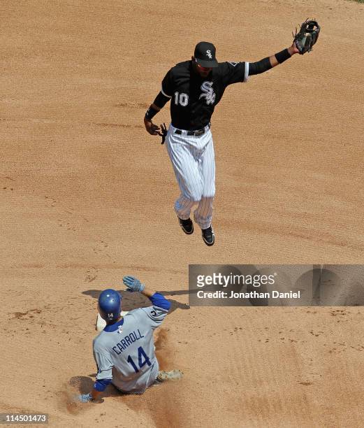 Alexei Ramirez of the Chicago White Sox leaps to try and catch a ball thrown by catcher A.J. Pierzynski as Jamey Carroll of the Los Angeles Dodgers...