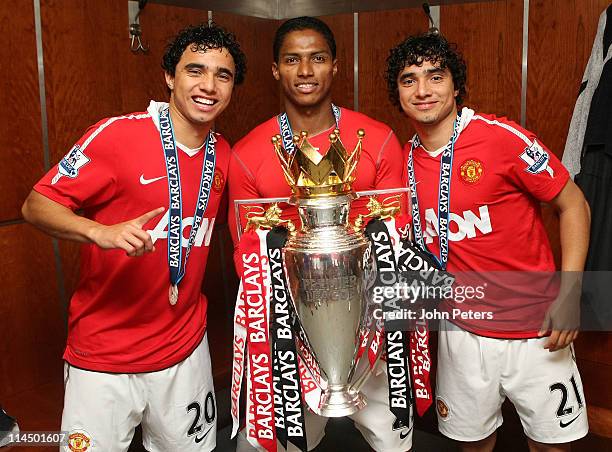 Fabio Da Silva, Antonio Valencia and Rafael Da Silva of Manchester United pose in the dressing room with the Barclays Premier League trophy after the...