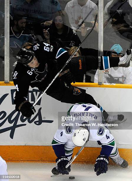Keith Ballard of the Vancouver Canucks throws the hip check on Jamie McGinn of the San Jose Sharks in the second period in Game Four of the Western...