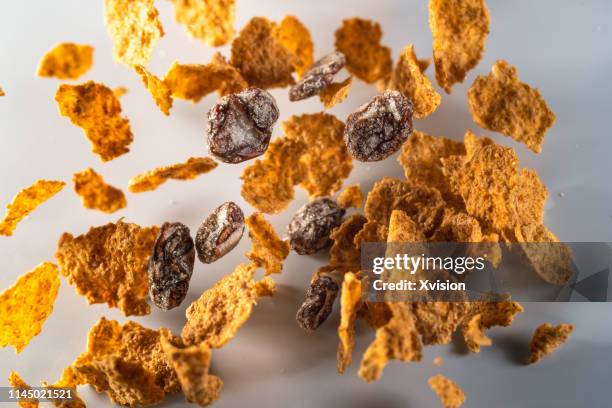 raisin wheat bran cereal taken in high speed"n - bran stock pictures, royalty-free photos & images