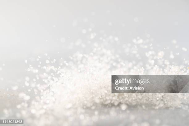 sugar small crystal dancing in mid air captured with highspeed camera"n - powdered sugar stock pictures, royalty-free photos & images