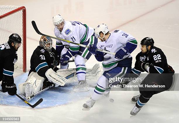 Goaltender Antti Niemi of the San Jose Sharks makes a save on a scoring attempt on the rebound from Jannik Hansen of the Vancouver Canucks in the...