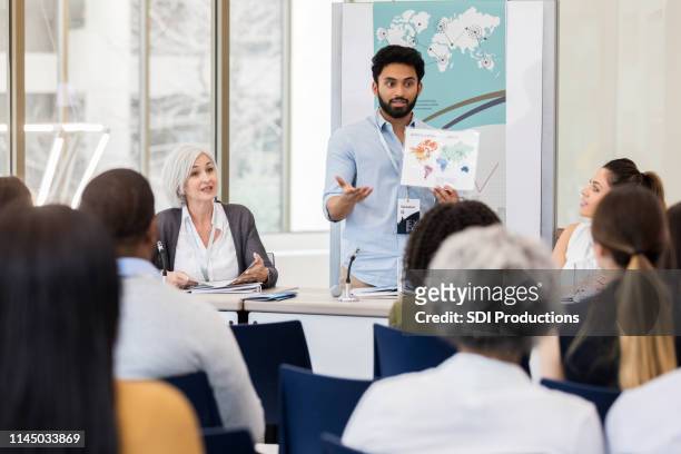 young international businessman discusses global business - panel discussion stock pictures, royalty-free photos & images