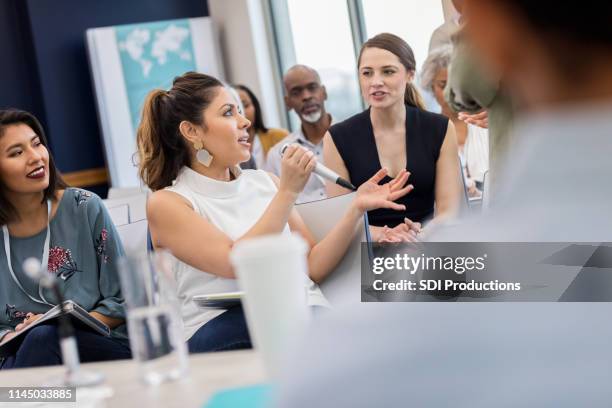 curious woman asks question during business conference - câmara municipal edifício do governo local imagens e fotografias de stock