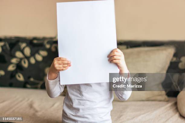 child with blank paper - kids placard stock pictures, royalty-free photos & images