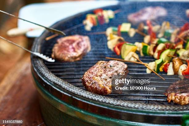succulent steak cooking on bbq grill with vegetables - grill party stockfoto's en -beelden