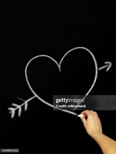 hand drawing  a heart with chalk in black board - chalk heart stock pictures, royalty-free photos & images