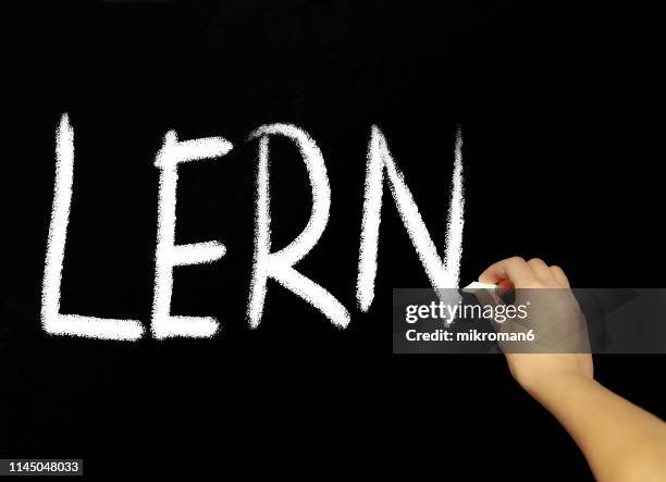 hand writing learn with chalk in black board - studierendenvertretung stock-fotos und bilder