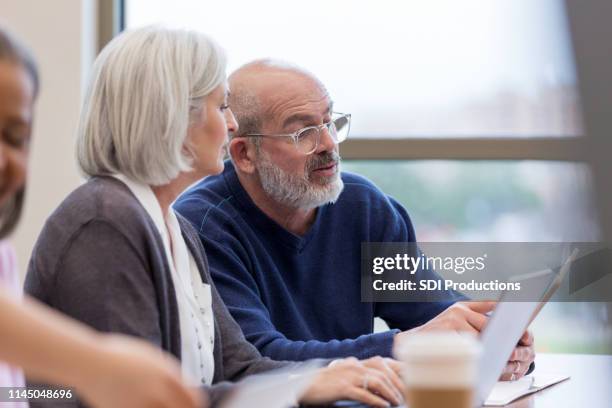 friends collaborate during spanish class. - old university stock pictures, royalty-free photos & images