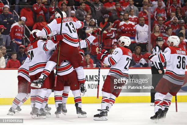Brock McGinn of the Carolina Hurricanes celebrates his game-winning goal with teammates against the Washington Capitals at 11:05 of the second...