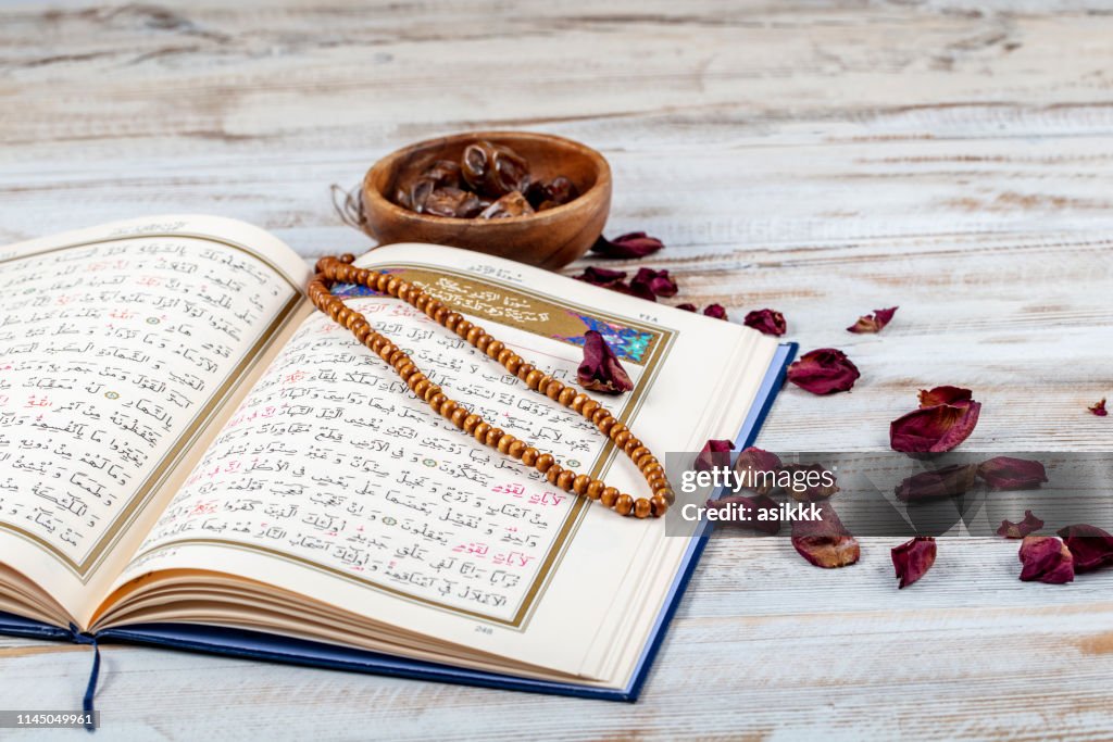 Koran - holy book of Muslims with rosary , date and dried flowers. ramadan concept