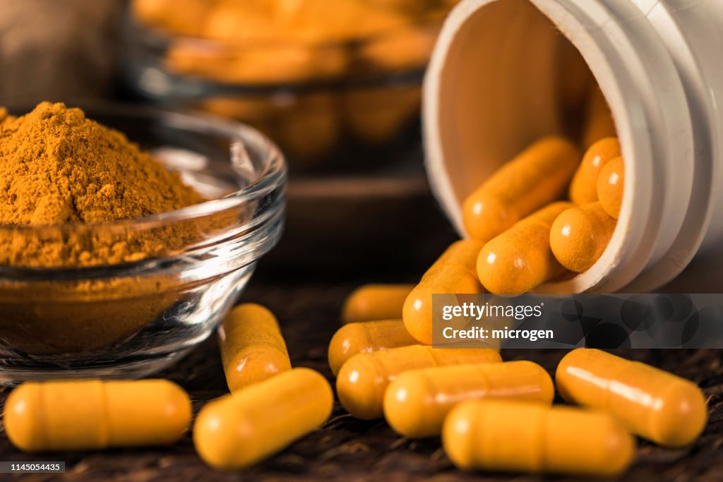 Curcumin Herbal Supplement Capsules and Turmeric Powder
