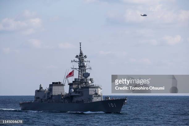 Japanese Maritime Self-Defense Force's Murasame destroyer sails near British Royal Navy's HMS Montrose frigate during a joint exercise with U.S. Navy...