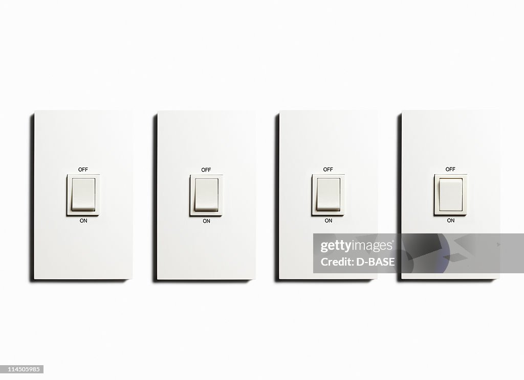 Four Light switch on  the white wall