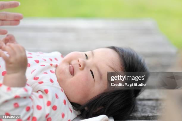 the baby being cradled - baby lying on back stock illustrations