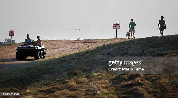 People traverse a levee on the edge of the Yazoo River floodwaters near Yazoo City May 22, 2011 in Yazoo County, Mississippi. The Yazoo River...