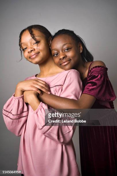 studio portrait of 2 african american teenage sisters - family formal portrait stock pictures, royalty-free photos & images