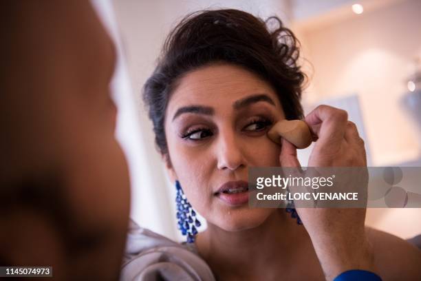 Indian actress Huma Qureshi gets ready before attending the screening of the film "A Hidden Life" at the 72nd edition of the Cannes Film Festival in...