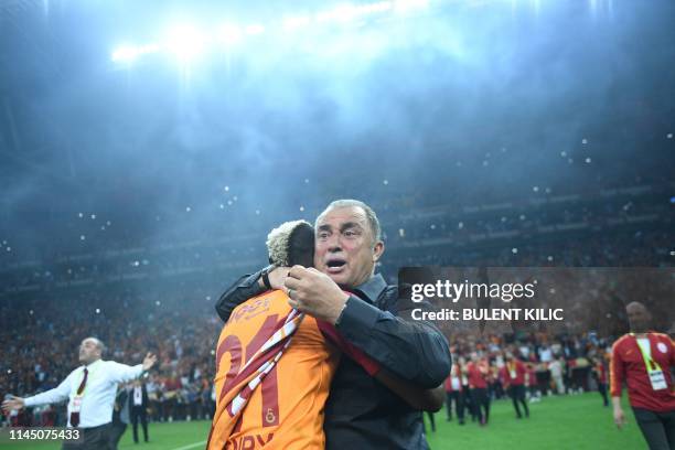 Galatasaray's Turkish head coach Fatih Terim and Nigerian forward Henry Onyekuru celebrate their Turkish championship title after winning the Turkish...