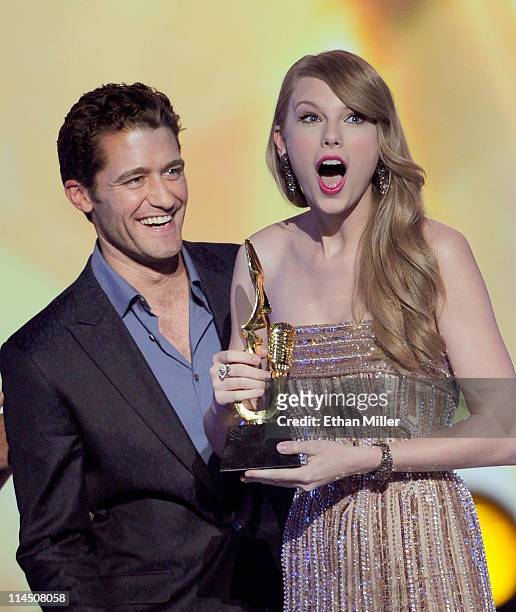 Actor/singer Matthew Morrison presents the Billboard 200 Album Artist of the Year award to singer Taylor Swift onstage during the 2011 Billboard...