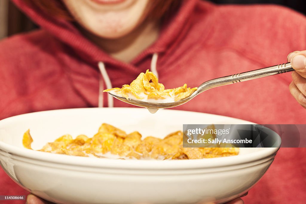 Girl eating bowl of breakfast cereal