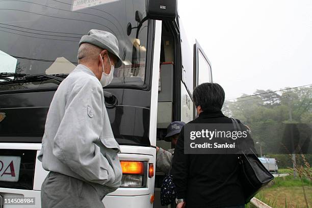 Kawamata City residents get on the bus to evacuate on May 22, 2011 in Kawamata, Fukushima, Japan. Though Kawamata City is located 30km from the...