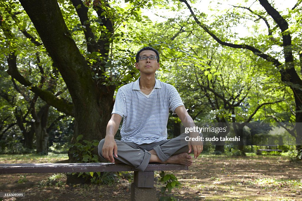 In the fresh green man sitting on a bench.