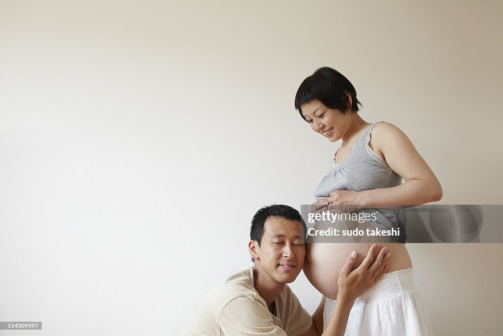 Men hear the beating of pregnant women belly