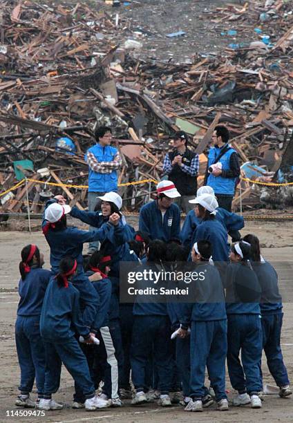 Otomo Junior High School students compete during the athletic meets held at debris-cleared Otomo Elementary School on May 22, 2011 in Rikuzentakata,...