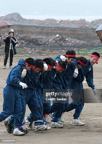 Otomo Junior High School students compete during the athletic meets held at debris-cleared Otomo Elementary School on May 22, 2011 in Rikuzentakata,...