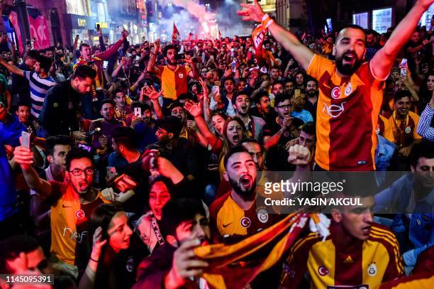 Galatasaray supporters celebrate after the football club was crowned champion of Turkey's top division for a record 22nd time on May 19, 2019 in...