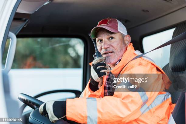 hispanic man driving a truck - walkie talkie stock pictures, royalty-free photos & images