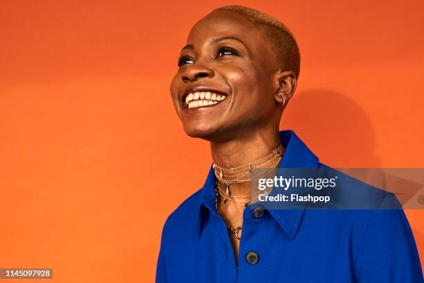 colourful studio portrait of a young woman - woman with orange stock-fotos und bilder