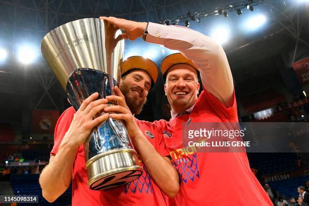 Moscow's Spanish guard Sergio Rodriguez and CSKA Moscow president Andrey Vatutin hold the trophy after winning the EuroLeague final basketball...