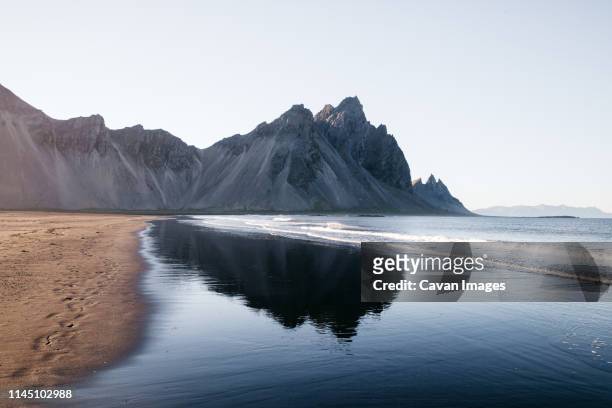 mountain reflection in iceland on the beach - cavan images stock pictures, royalty-free photos & images