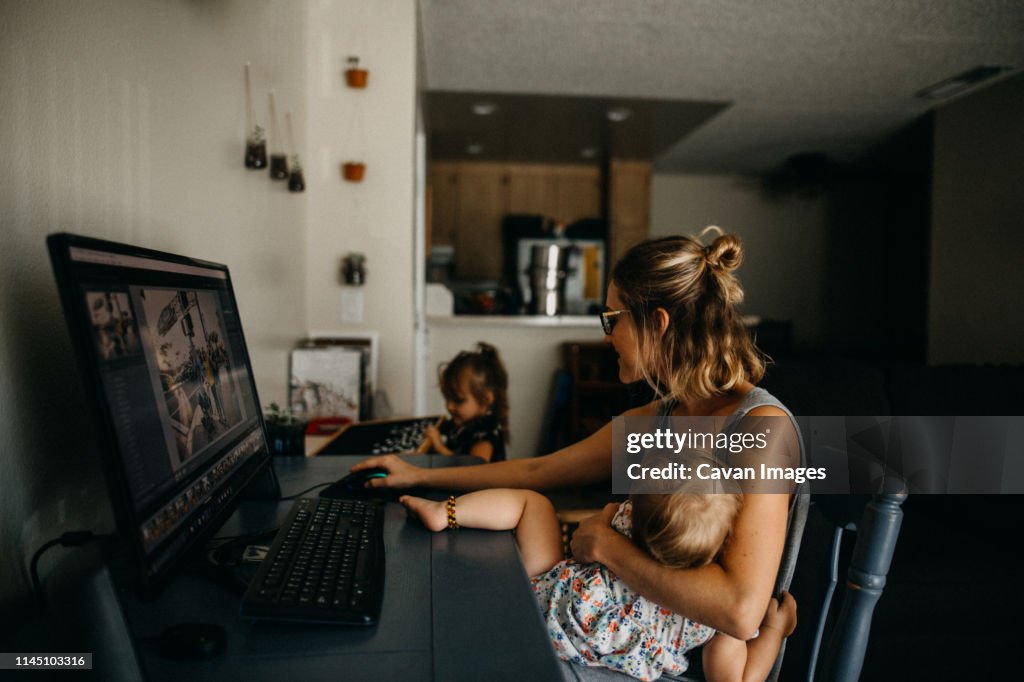 Workload Computer Baby Working Mother Multitasking On The Computer And Holding Baby High-Res ...