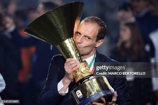 Juventus' Italian coach Massimiliano Allegri kisses the champion's trophy at the end of the Italian Serie A football match Juventus vs Atalanta on...