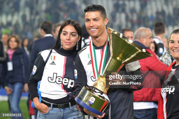 Cristiano Ronaldo of Juventus FC and Georgina Rodriguez celebrate with the trophy after winning the Serie A Championship at the end of the serie A...