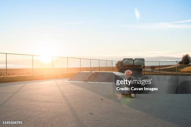 young boy riding hover board at skate park with big smile - half pipe stock-fotos und bilder