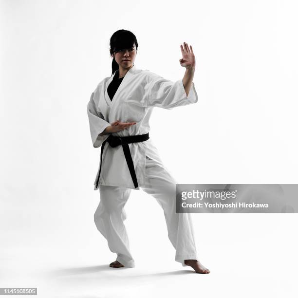young teen japanese woman doing karate - martial arts stock pictures, royalty-free photos & images