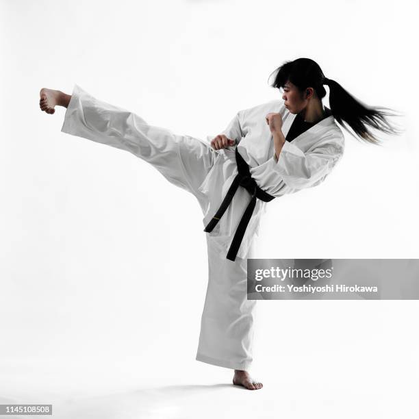 young teen japanese woman doing karate - karateka stock-fotos und bilder