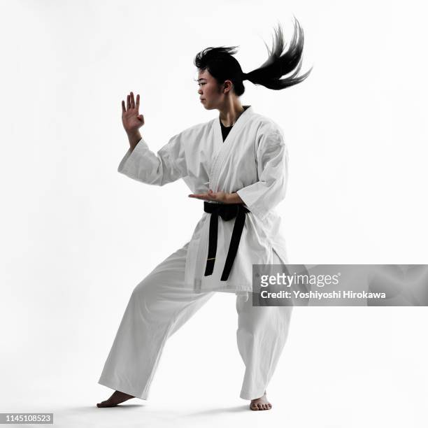 young teen japanese woman doing karate - verteidigen stock-fotos und bilder